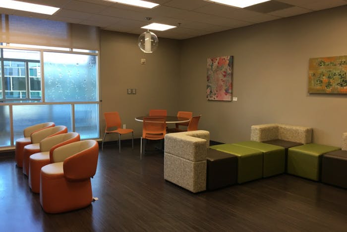 Previous empty Teen Room with some chair and a table at Dell Children's Medical Center