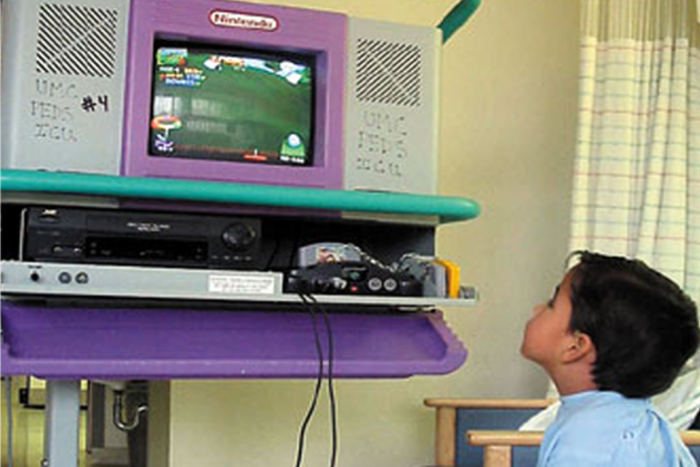A seriously ill child enjoying video games on our Starlight Nintendo 64 console in the hospital (1998). 