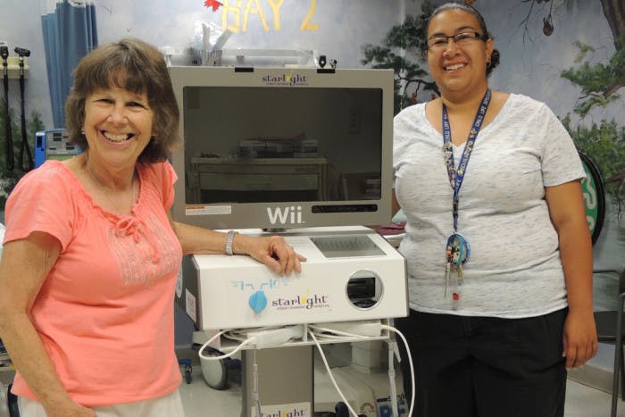 Jo Anne on left in Childrens Hospital of New Mexico with a Starlight Wii Gaming Station