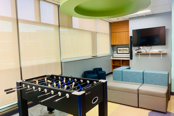 Updated Tween Room at Dell Children's Medical Center with a foosball table, computer, and tv