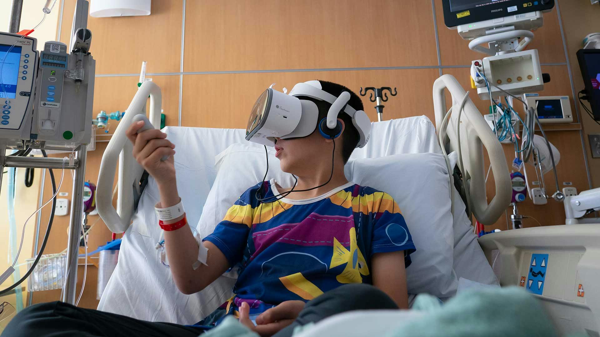 Boy Playing with Virtual Reality in Hospital Bed